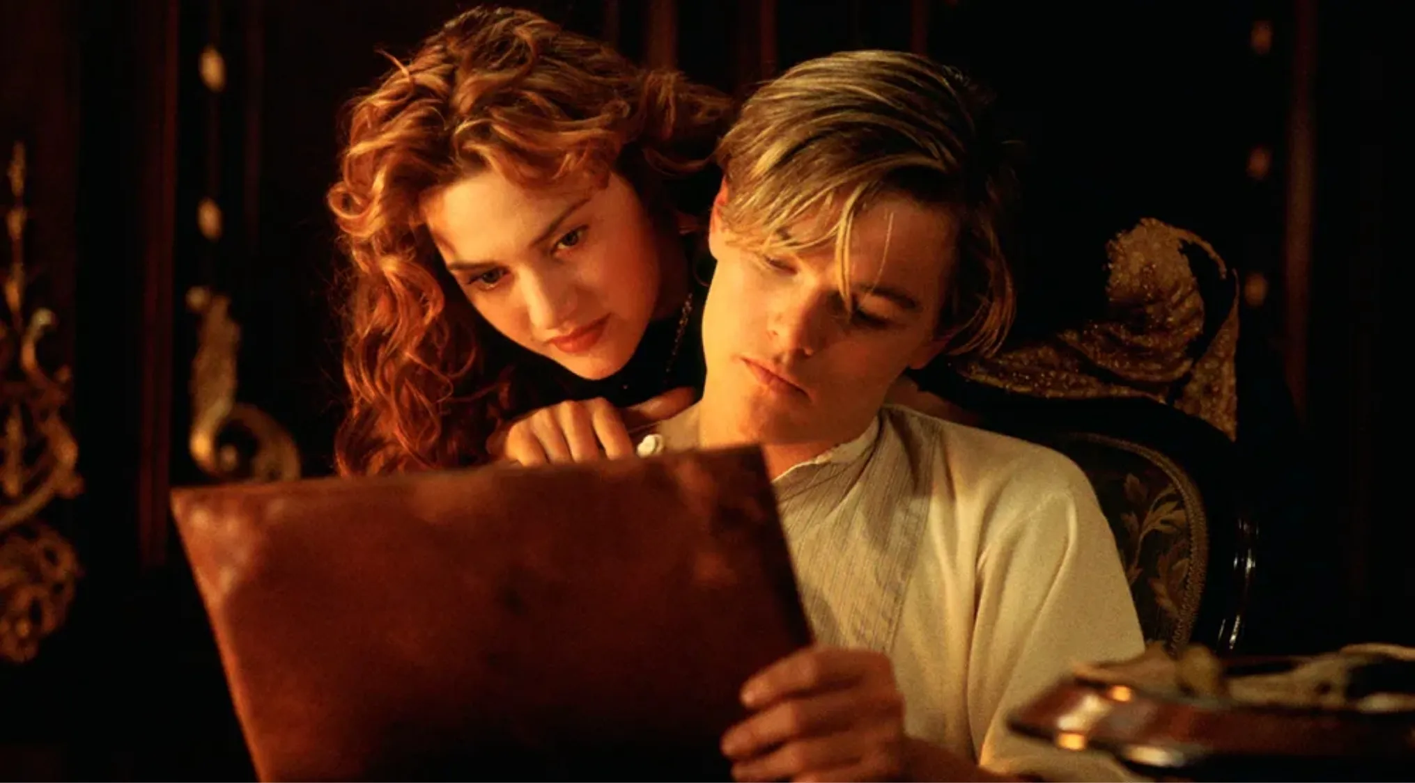 Scene from Titanic with characters looking at a document, relevant to trivia night and Titanic Academy Awards question.