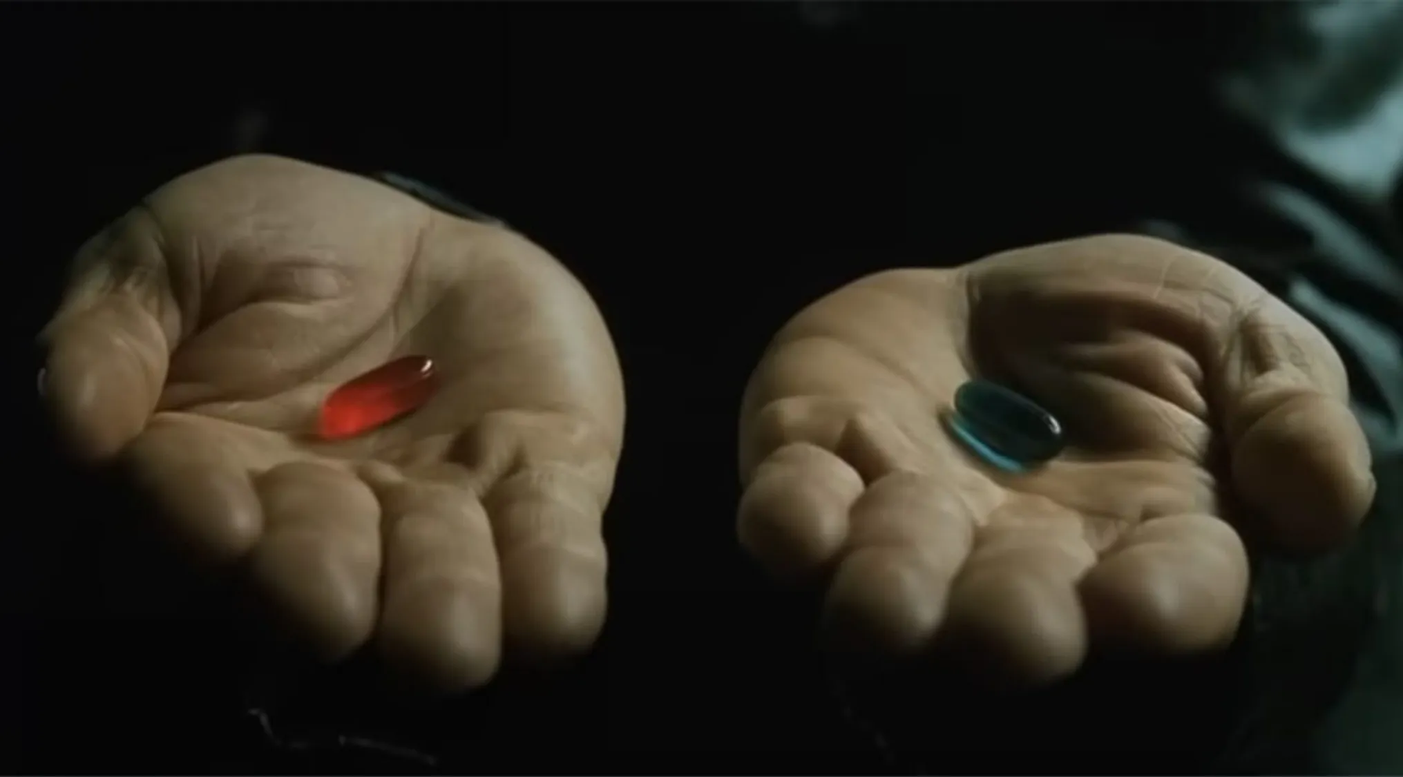 Hands holding a red pill and a blue pill symbolizing the color pill Neo takes in The Matrix trivia night question.