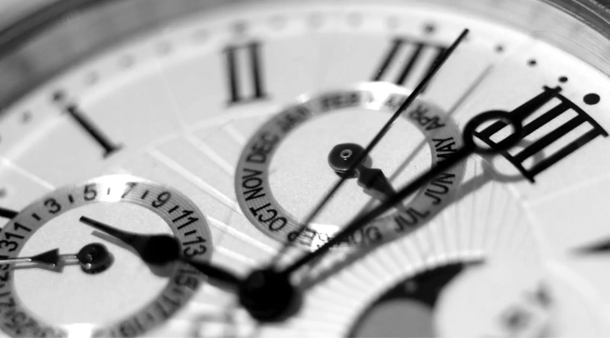 Close-up of a watch face showing Roman numerals, focusing on the numeral for 100 in classic timepiece design.