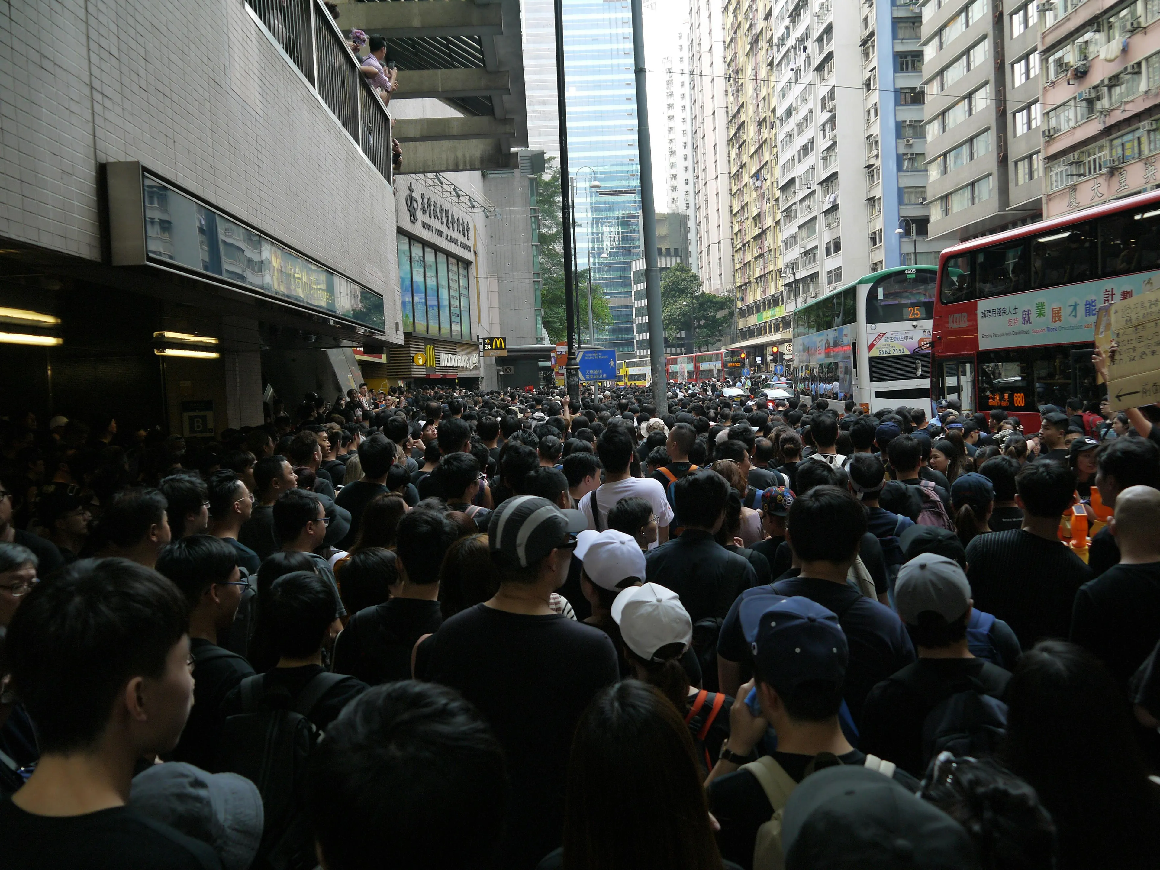 Crowded urban street scene with hundreds of people illustrating population genetics in a dense environment.