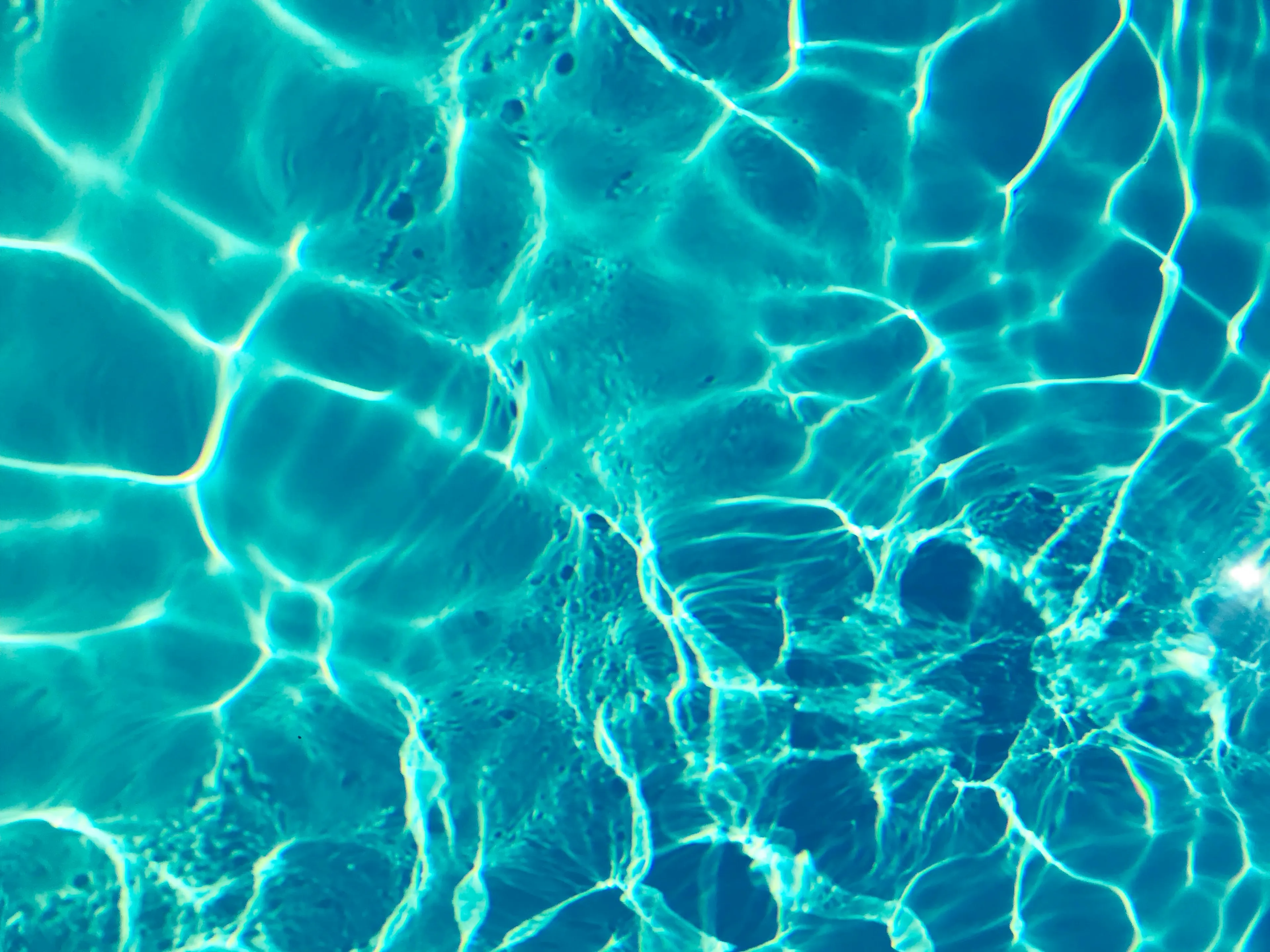 Light wavelength change shown by bright patterns on blue water surface representing science general knowledge concept.