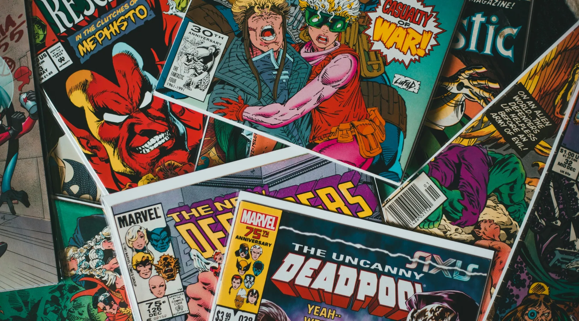 Collection of comic books displayed, featuring Deadpool and other supervillains linked to black-ops missions in 2016 movies.