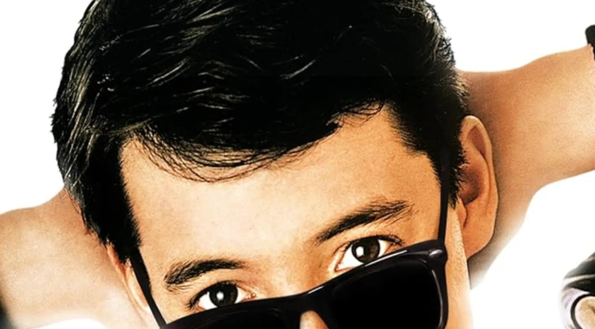 Close-up of a man wearing black sunglasses, featured in a movie quiz anniversary edition cover.