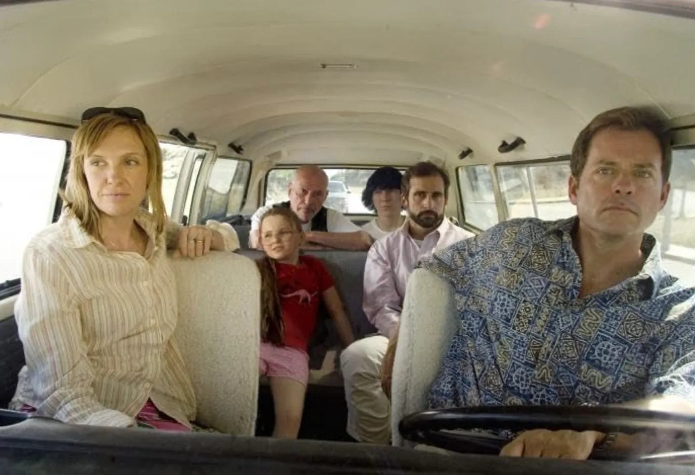 Cast of the movie celebrating 30 years in 2026 sitting inside a vintage van during a road trip scene.