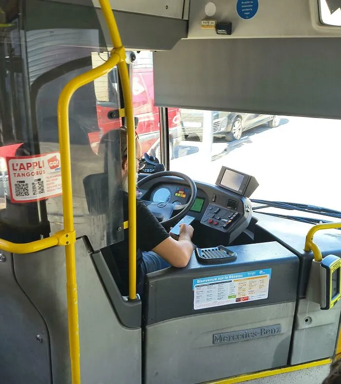 My Bus Driver On His Personal Phone, While Actively Driving. He Is Not Checking The Route Or Stops- That One Was Mounted In Front Of Him