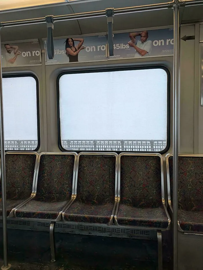 Empty subway seats with windows covered in snow during a snowstorm hitting the U.S. in winter.