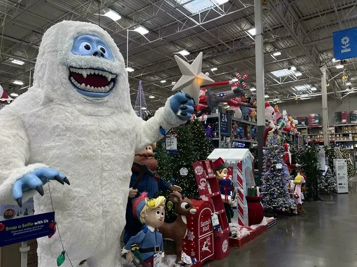 Holiday consumerism display featuring animated Christmas decorations and festive merchandise in a large retail store aisle