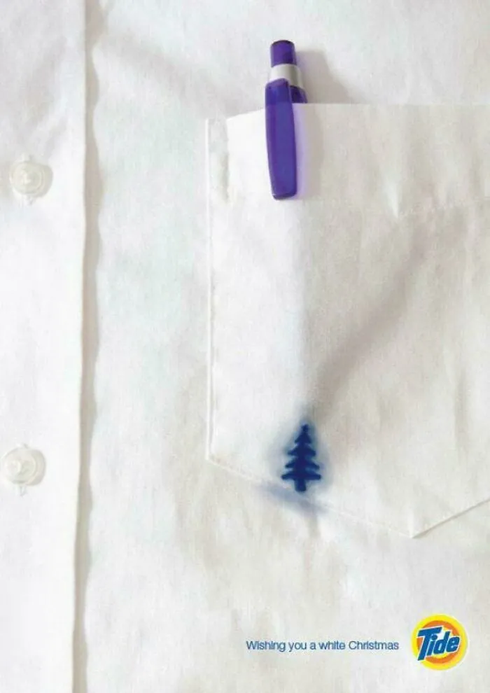 White shirt pocket with blue pen and small blue tree stain
