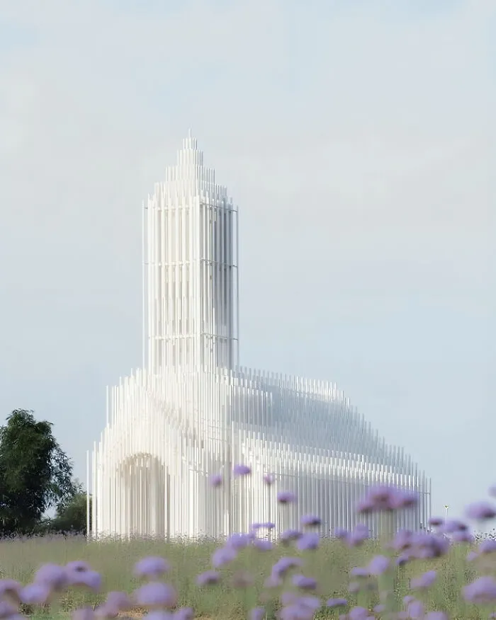 Modern white minimalism style church building in natural setting with flowers in foreground