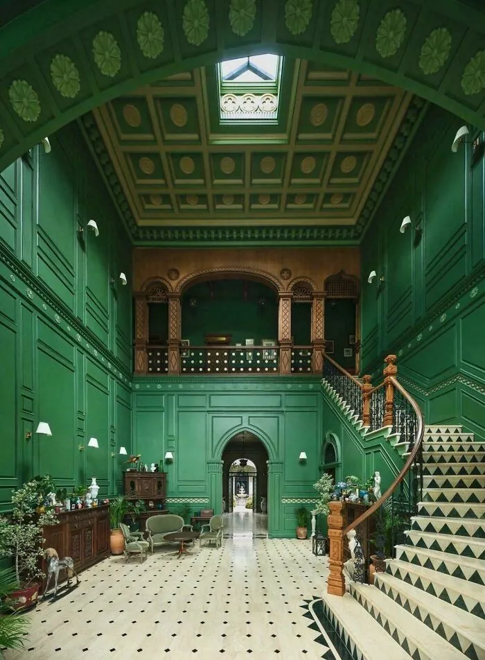 Interior design with green walls and staircase in elegant room decor
