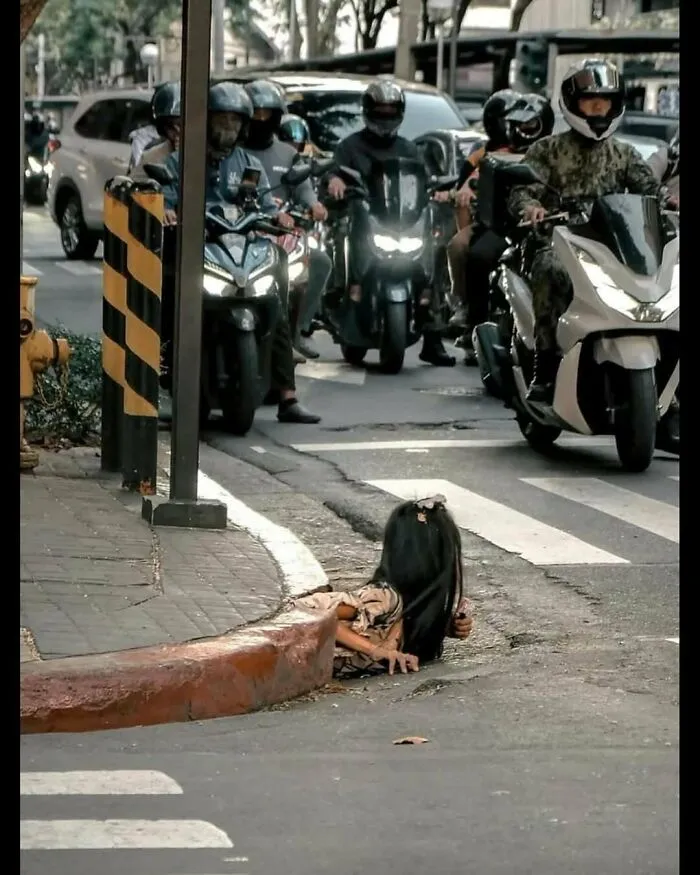 A Woman Crawling Out Of A Drainage Tunnel In The Philippines, Known As The “Mole People” That Shelter Beneath The City