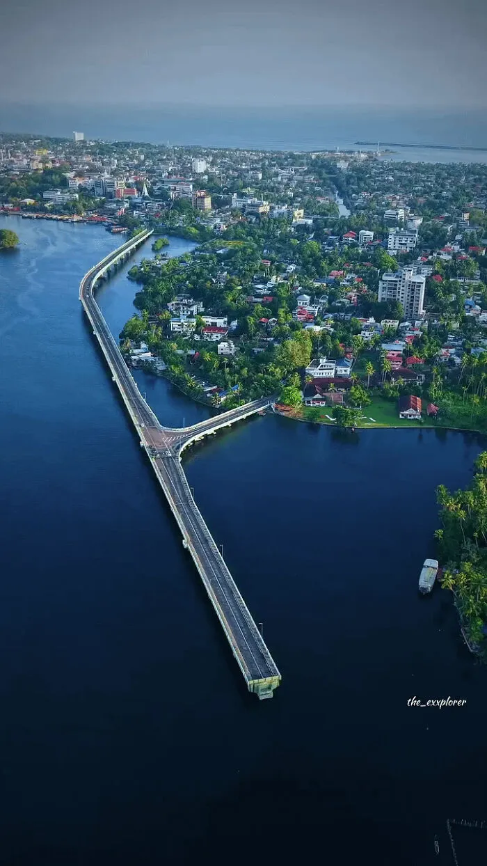 Aerial view of urban landscape with a bridge over water, showing modern life and dystopian urban hell contrasts.
