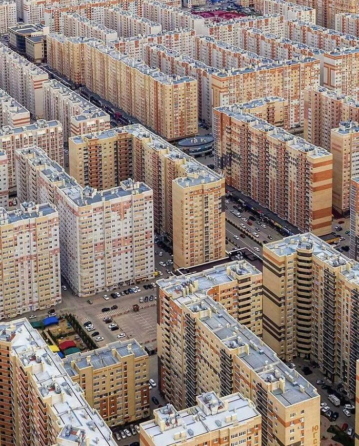 Aerial view of dense urban housing blocks illustrating dystopian urban hell and the true price of modern life.