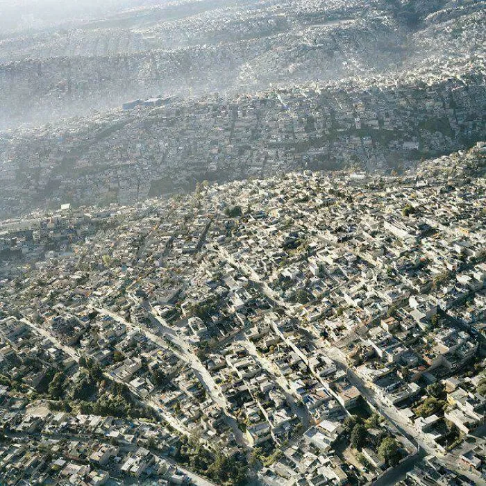 Aerial view of a densely packed urban area illustrating dystopian urban hell and the true price of modern life.