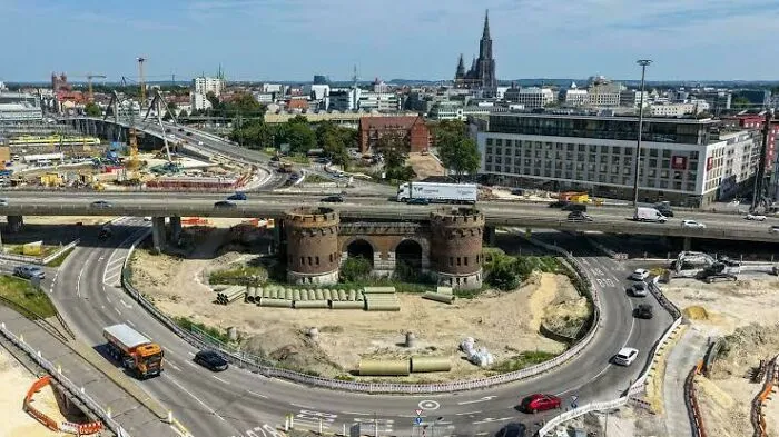 Aerial view of a complex urban highway interchange and construction site illustrating dystopian urban hell in modern city life.