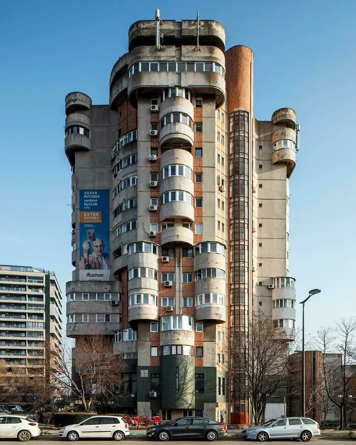 Brutalist apartment building in urban hell setting, showing dystopian architecture and the true price of modern life.