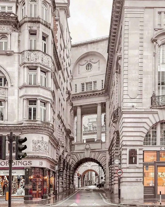 Beautiful architecture featuring a street with arched walkways and ornate buildings, showcasing unreal details.