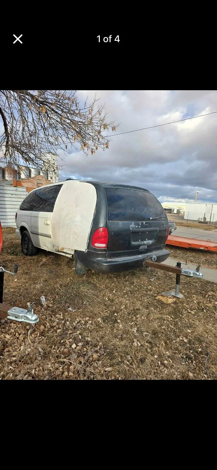 Half black and half white vehicle with improvised door panel and a trailer hitch attachment, example of redneck engineering.