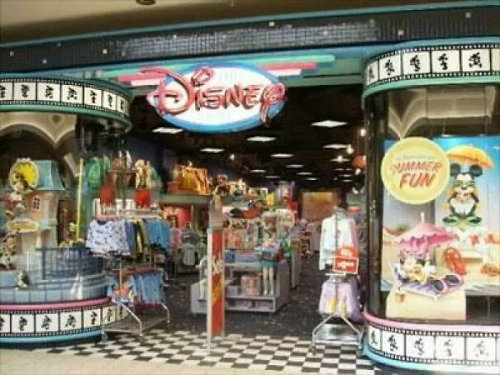 Disney store entrance with ’90s merchandise and summer fun display, evoking funny ’90s posts and childhood memories.