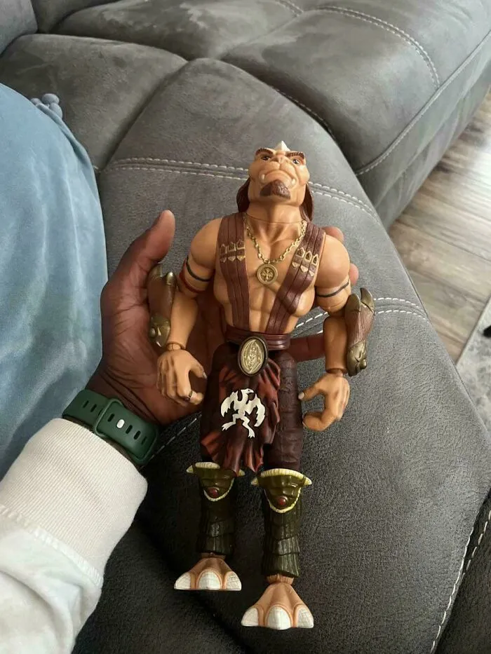 Hand holding a 90s action figure toy, capturing nostalgic childhood memories from the 90s era.