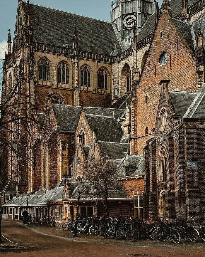 Historic European architecture with a tall church and brick buildings, showcasing beautiful architecture.