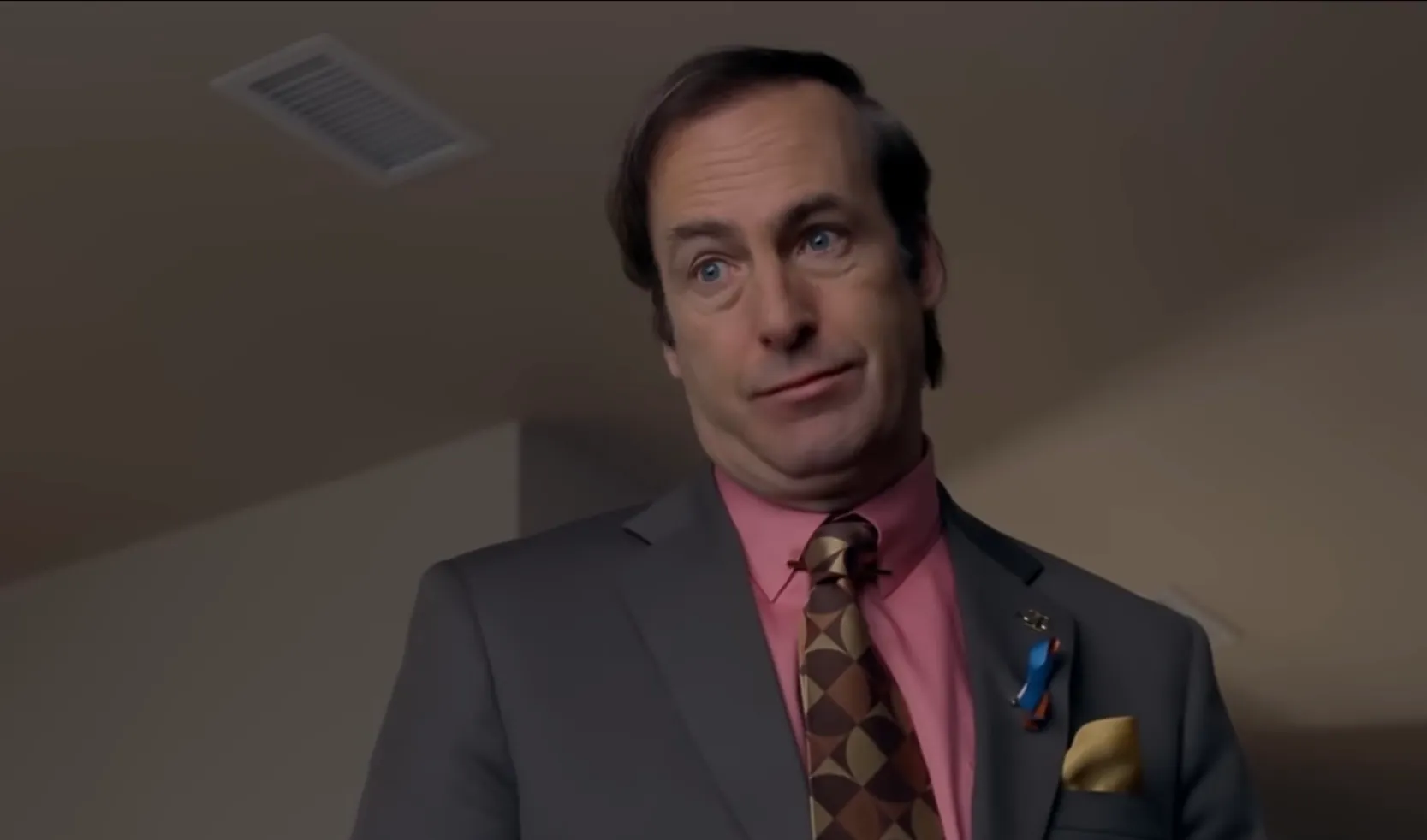 Bob Odenkirk as the morally conflicted chemistry teacher-turned-criminal in Breaking Bad wearing a suit and patterned tie.