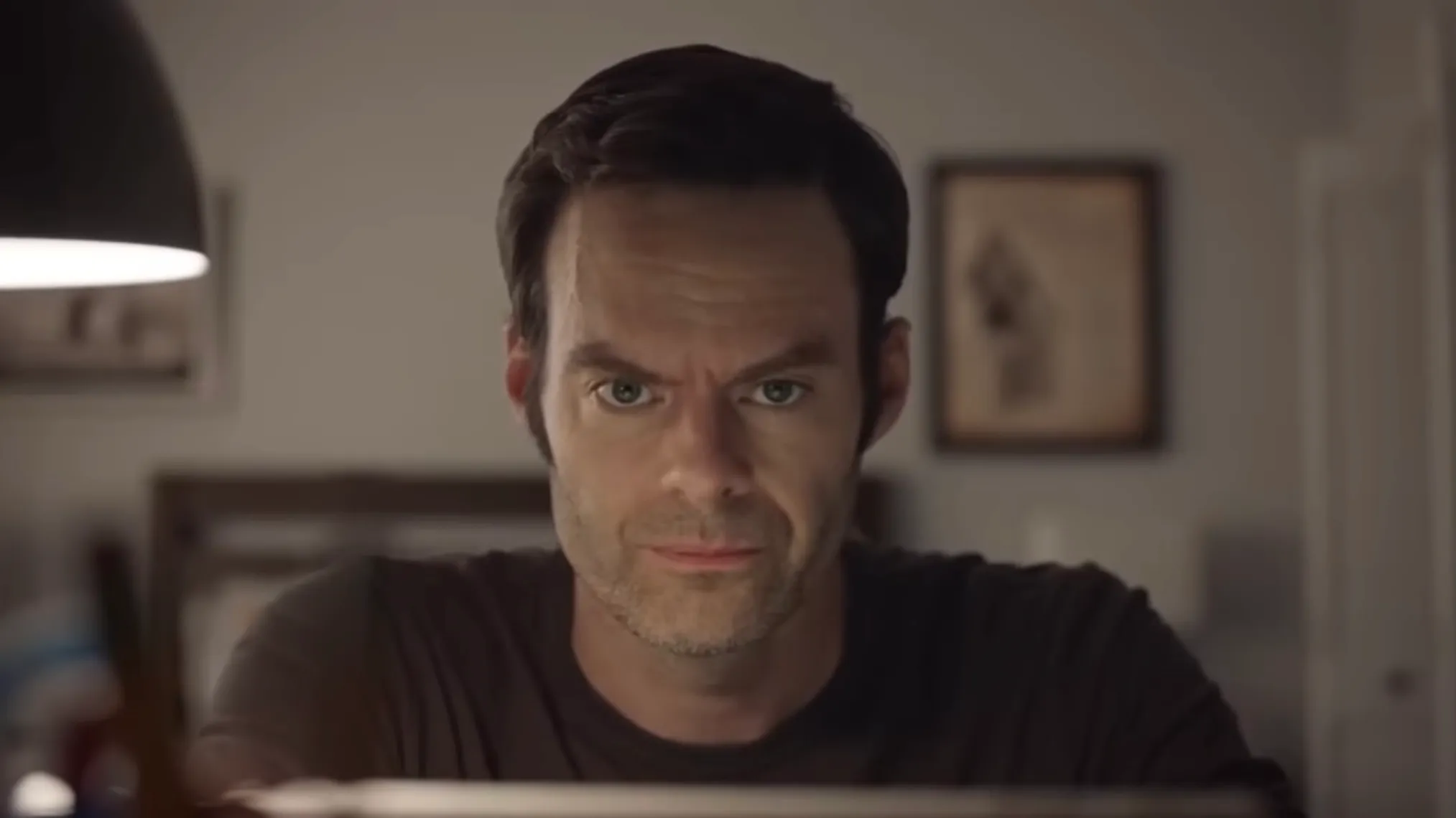 Bill Hader portraying the morally conflicted chemistry teacher-turned-criminal in Breaking Bad, focused in a dimly lit room.