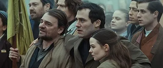 A group of misfit CIA operatives standing closely together during a tense moment in a spy comedy series.