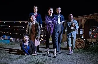 Group of misfit CIA operatives standing outdoors at night in a chaotic spy comedy scene with string lights overhead.