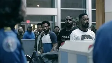 Group of misfit CIA operatives standing in line at an airport security checkpoint during a chaotic spy comedy mission.