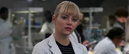Actress Emma Stone in a white lab coat portraying Meredith Grey in a medical drama setting with a focused expression.