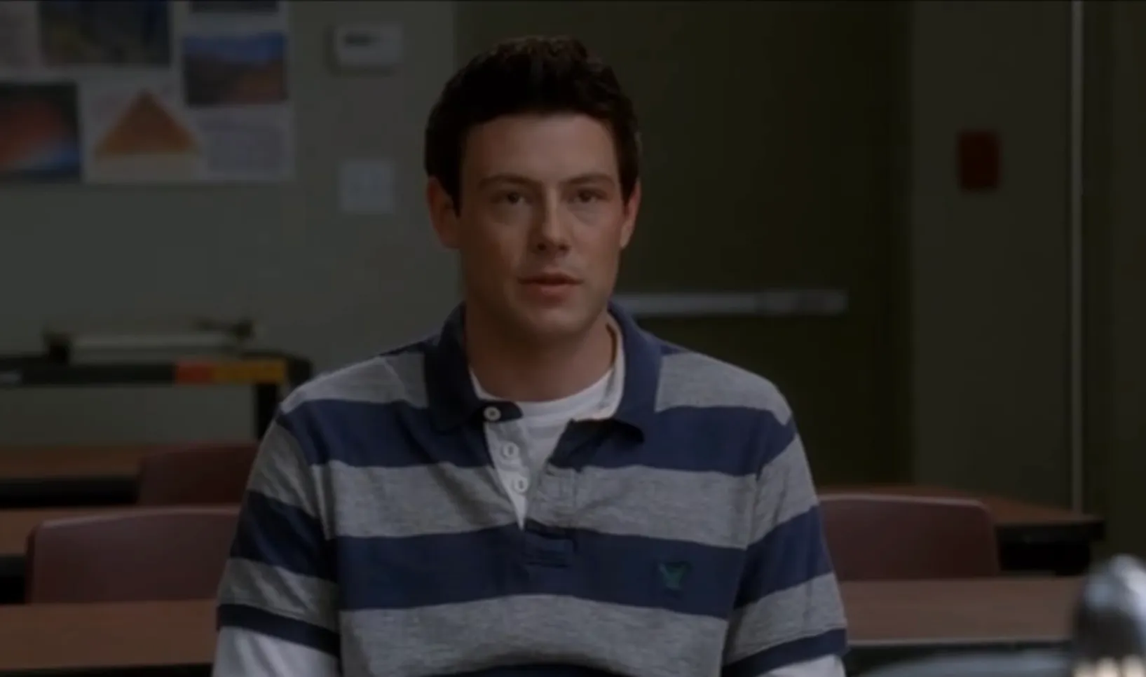 Young man in a striped polo shirt sitting in a classroom scene from Friends as Phoebe’s long-lost half-brother Finn Hudson.