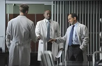 Three doctors in discussion inside a hospital, featuring a brilliant but abrasive diagnostician named Gregory from House M.D.