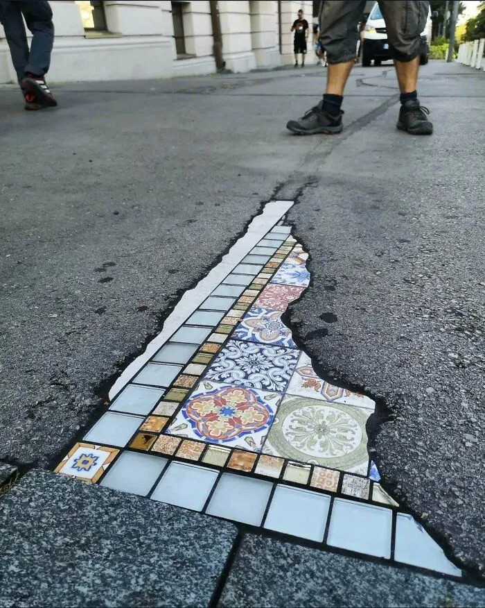 French Artist “Ememem” Paves Cracks And Holes With Mosaics. This Is Also Known As “Flacking”