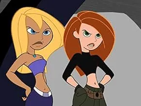 Two animated characters, a confident blonde and a redhead, stand ready, hinting at a spy thriller cat-and-mouse chase.