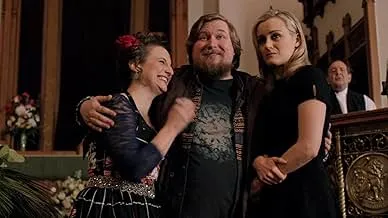Three actors smiling together from the prison drama Orange Is the New Black.