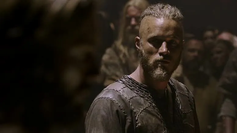 Viking warrior in dimly lit scene from TV shows depicting Ragnar Lothbrok and his descendants’ life story.