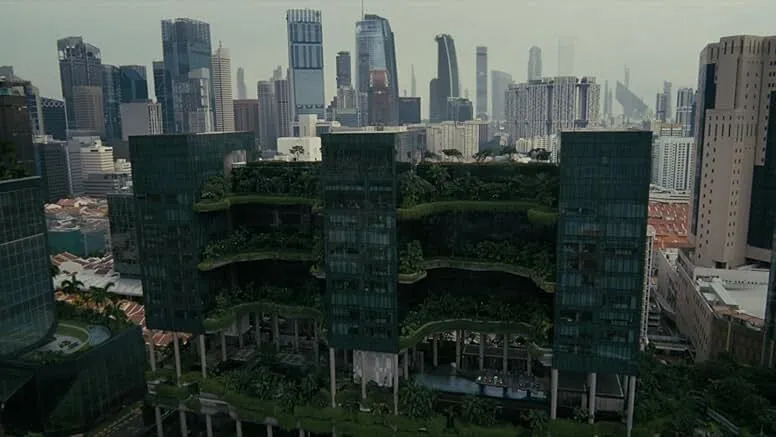Futuristic cityscape featuring a high-rise building with lush greenery in a theme park inspired by lifelike androids.