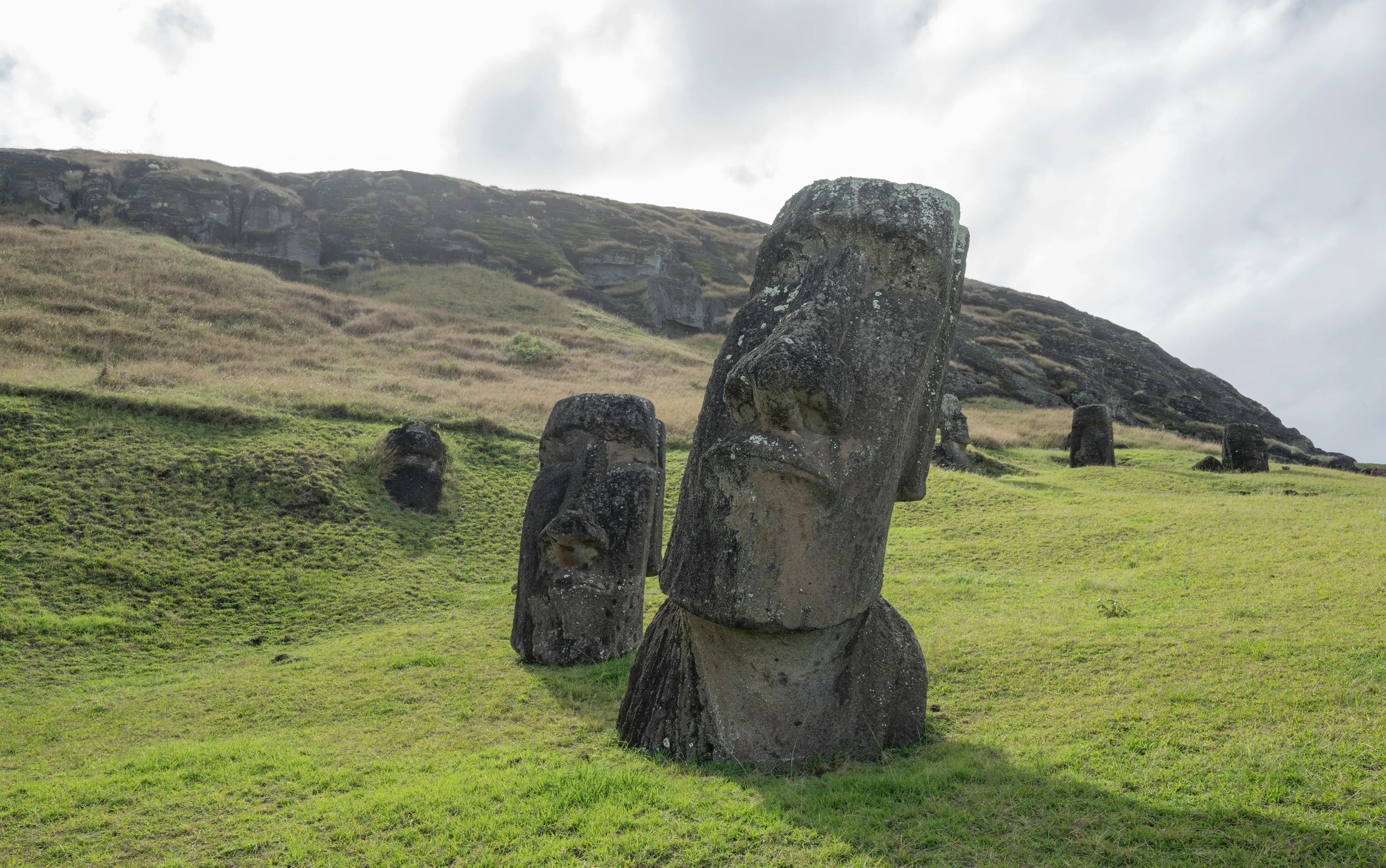 Moai stone statues on grassy hills at Easter Island, challenging you to guess this country from a single picture.