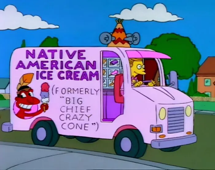 The Simpsons ice cream truck with a Native American sign and a purple color scheme on a suburban street.