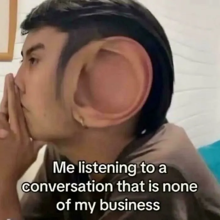 Person with an exaggerated large ear listening intently, representing hilarious relatable memes about eavesdropping on conversations.
