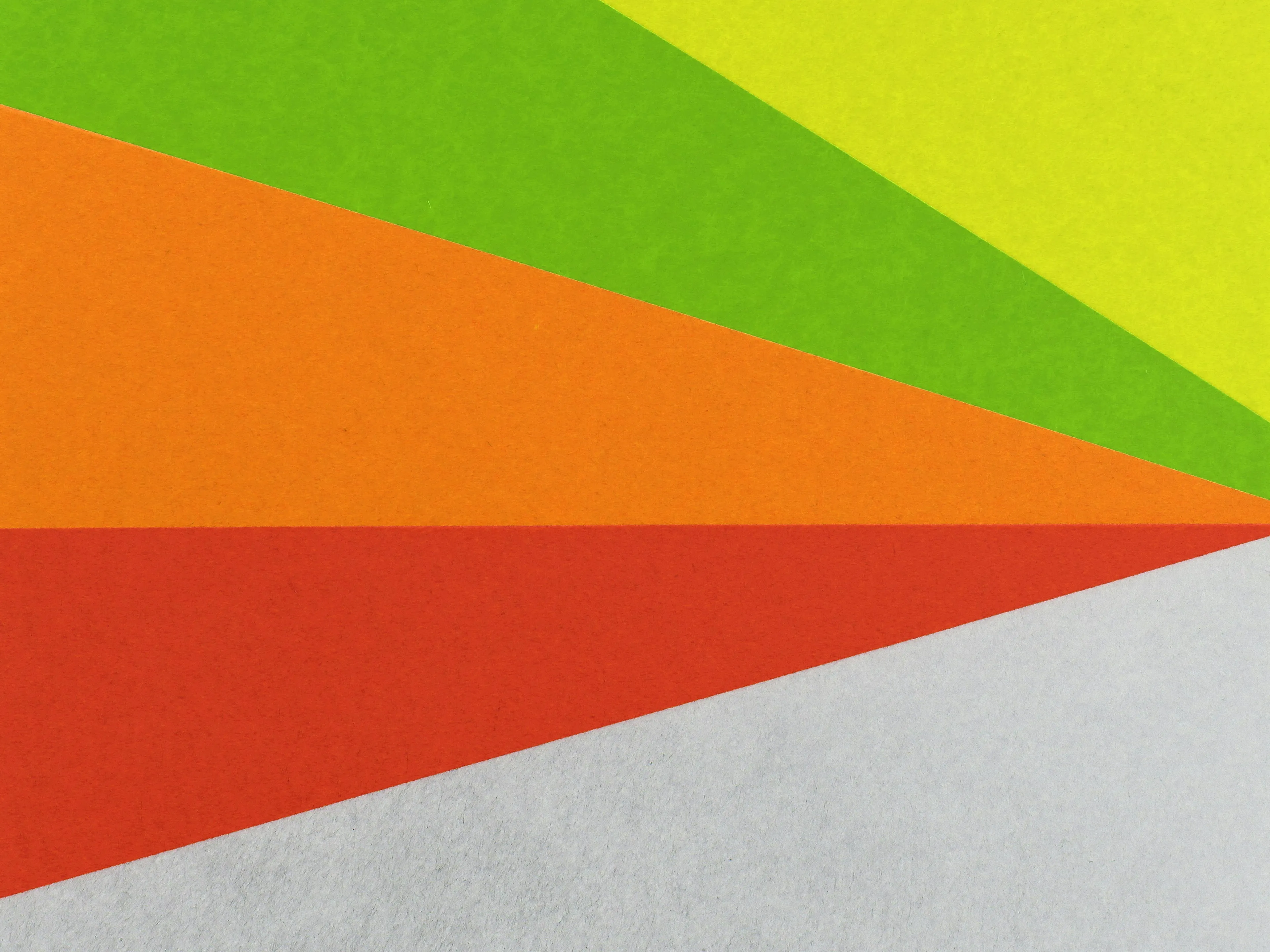 Abstract colorful paper shapes arranged in rainbow pattern focusing on arts and primary colors concept.