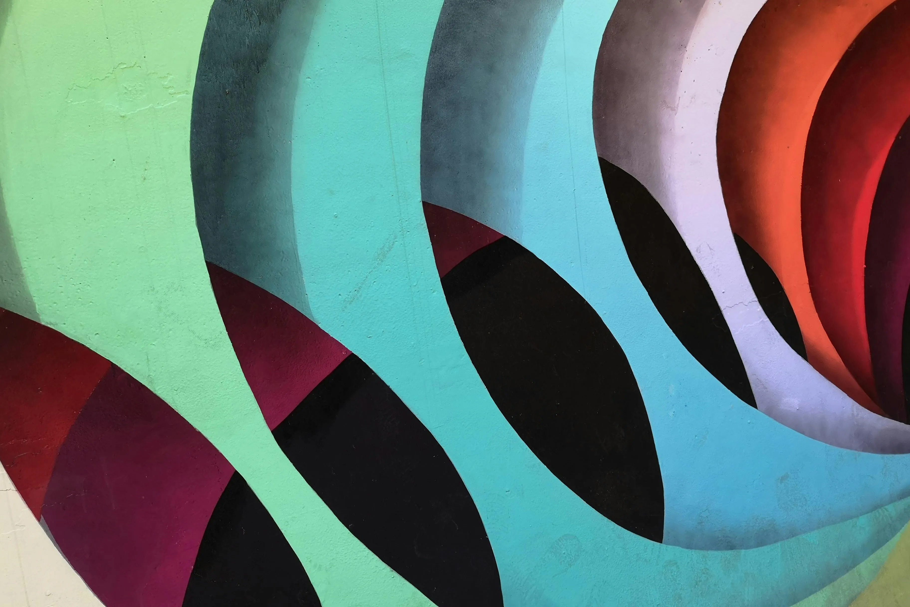 Colorful abstract art with overlapping curved shapes and contrasting hues, illustrating characteristics of abstract art style.