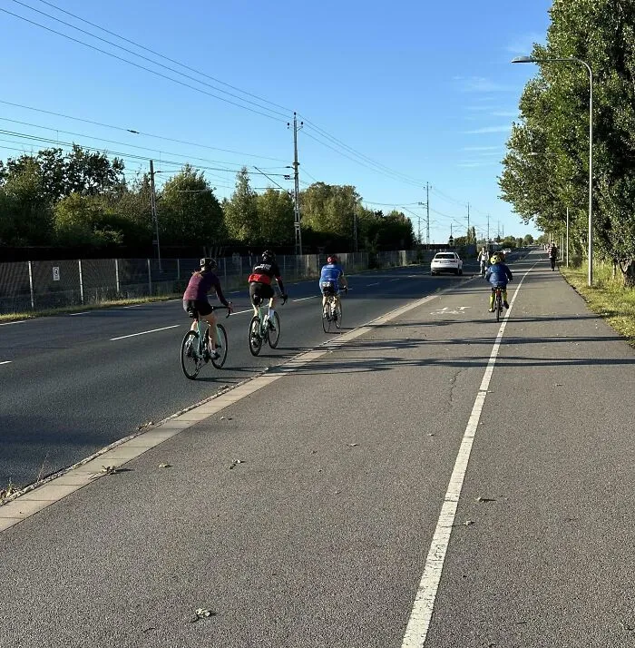 Cyclists Riding On Road, Next To Bike Lane