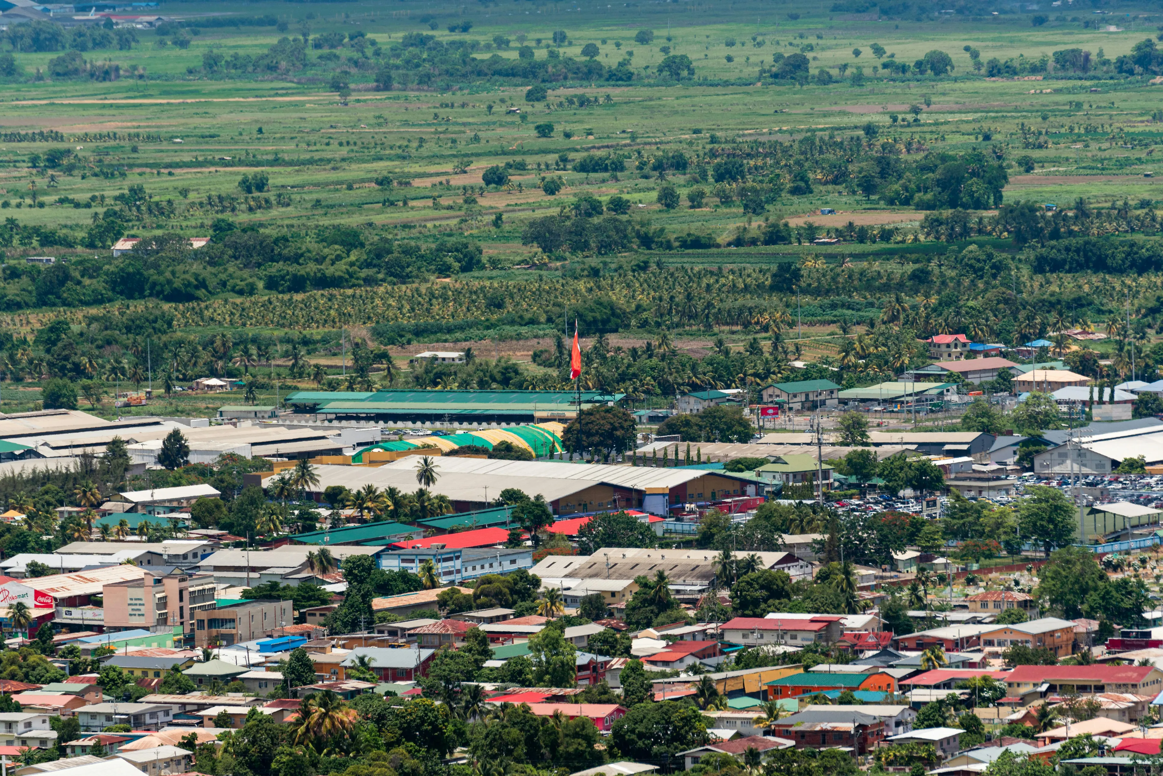 Aerial view of colorful buildings and greenery in a Caribbean country of Trinidad and Tobago near Venezuela.