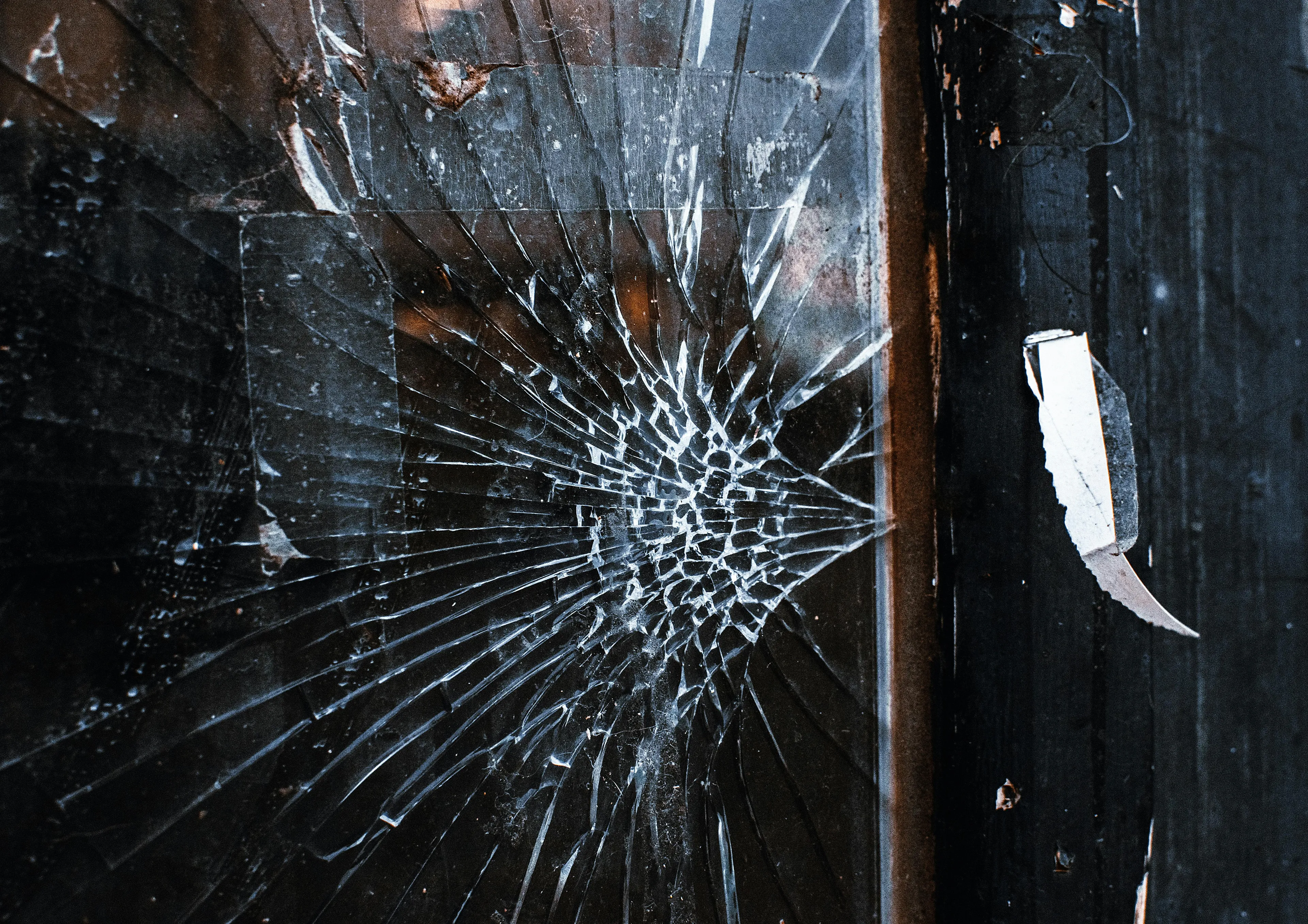 Close-up of a cracked mirror symbolizing identity uncertainty in literature and school questions about short stories.