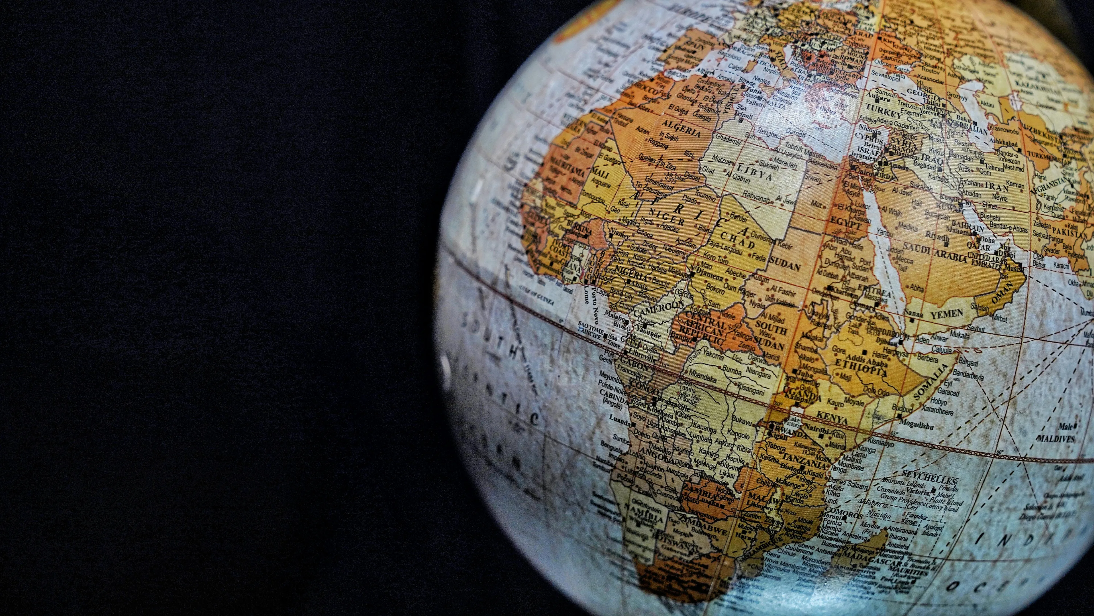 Close-up of a globe showing Africa and surrounding regions, highlighting natural features forming country boundaries in geography.