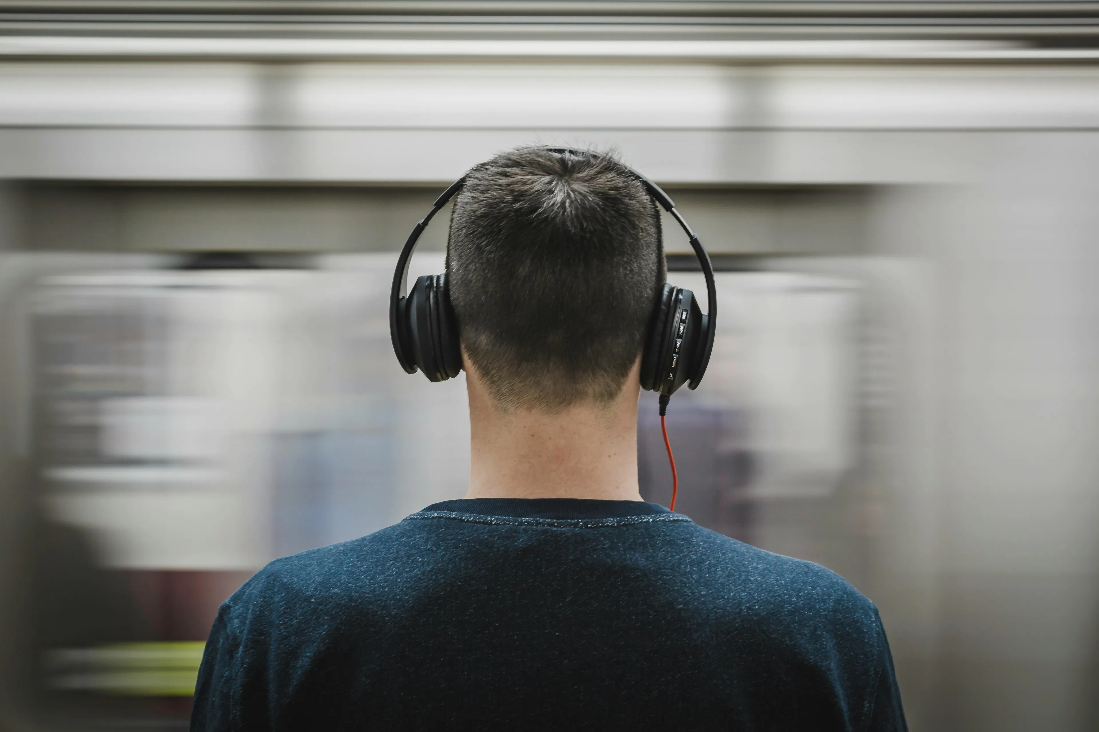 Person wearing headphones listening to music as a song gradually increases in speed creating a sense of urgency.