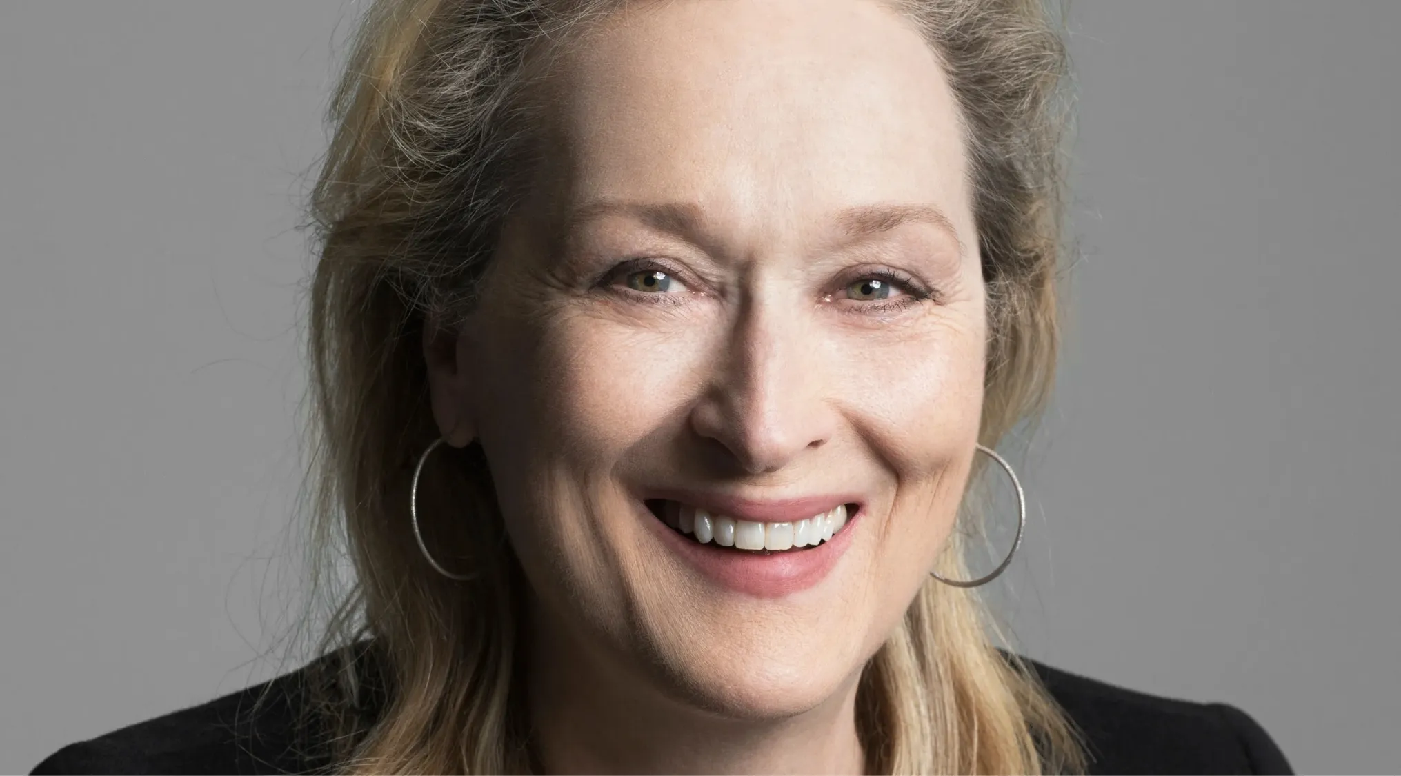 Close-up of Meryl Streep smiling, highlighting her role as a side character in a popular movie guessing challenge.