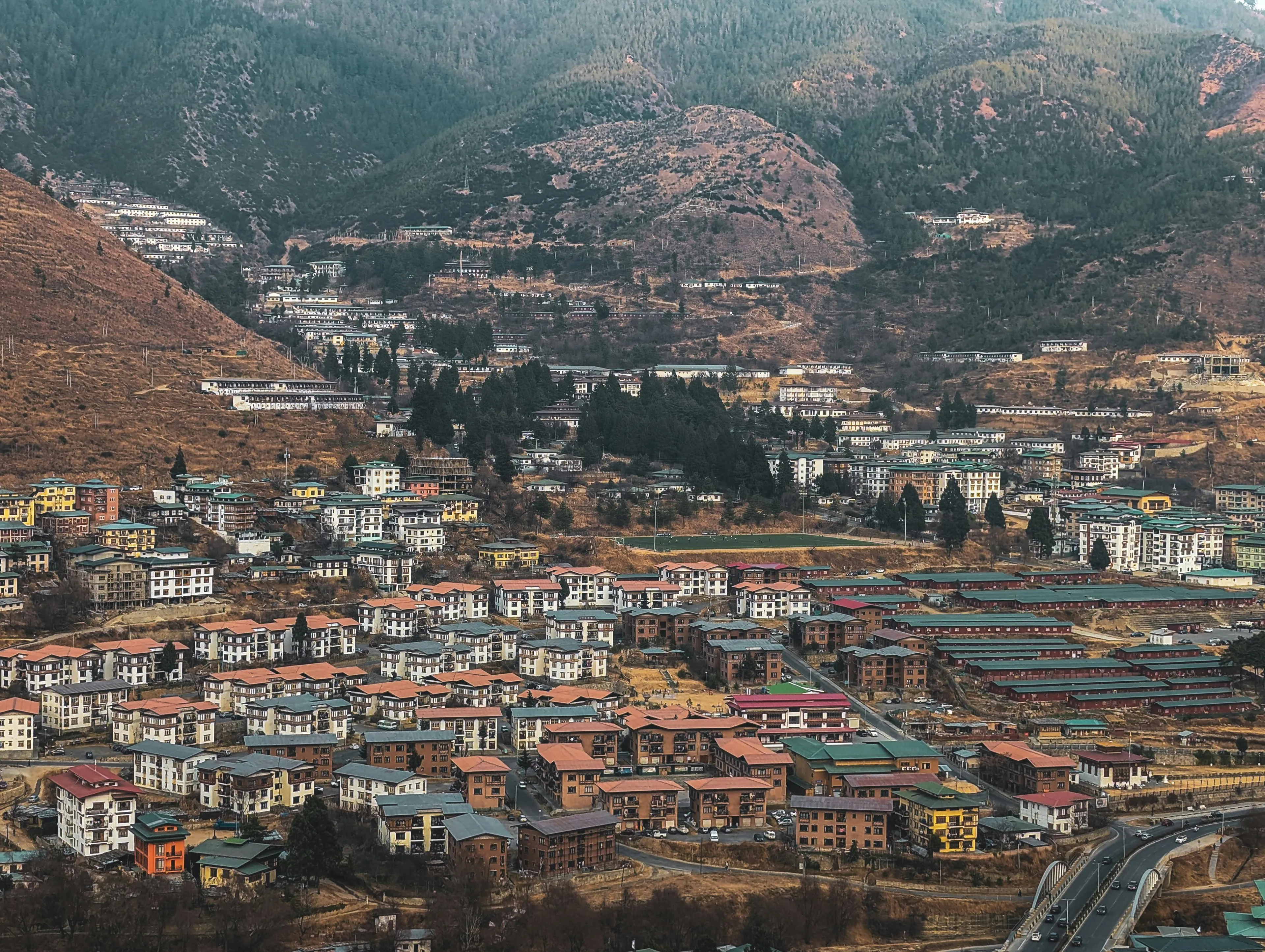 Aerial view of mountain town in Bhutan, known for its government-mandated Gross National Happiness index.